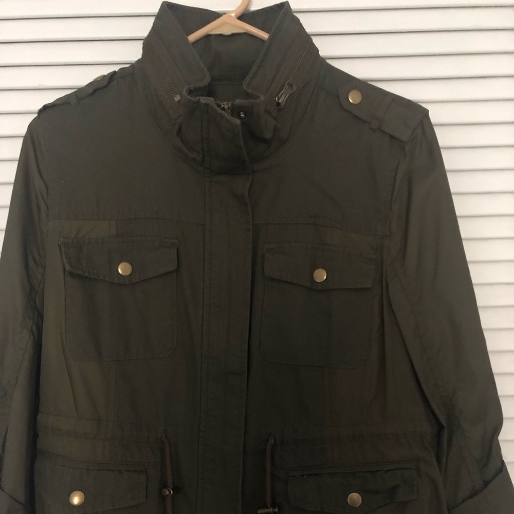 American Rag cinched waist zip jacket with 4 snap close pockets.
